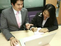 Dolly: Businesswoman Working laptop with manager coaching Stock Footage