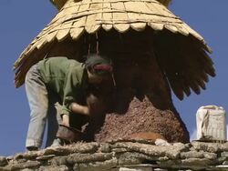 WS Pan Ladies painting buddhist chorten wall/ Saldang village, High Himalayas, Upper Dolpo near Tibetan border, Nepal buddhist chorten tower  Stock Footage