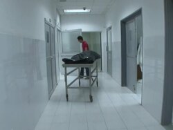 MS ZI Shot of Mexican CSI deliver body to coroner AUDIO / Ciudad Juarez, Juarez, Mexico Stock Footage