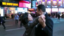 Young couple dancing in the street in Times Square Stock Footage