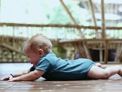 MS Shot of baby trying to crawl / Ubud, Bali, Indonesia Stock Footage