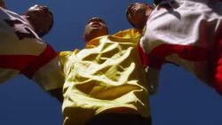 A team of soccer players jump around in a huddle. Stock Footage