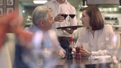 MS PAN Man and woman in restaurant, waiter serving wine Stock Footage