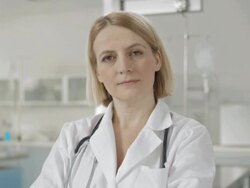 Female Doctor Nodding At The Camera Stock Footage