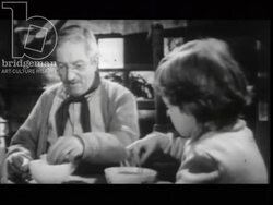 Old man and young girl drink tea together. France, 1960 Stock Footage