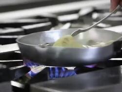 Close up shot of a chef cooking seafood spaghetti into a pan Stock Footage