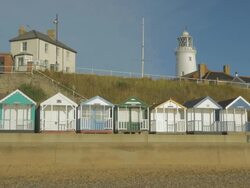 Southwold,colourful beach huts,Jogger,gLighthouse,MS Stock Footage