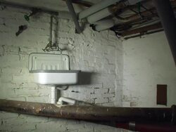 Dark basement with a sink and pipes Stock Footage