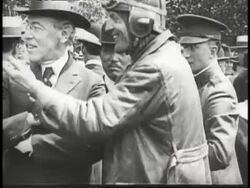 A montage shows a man dropping a letter into a mail bag, men loading mail into a biplane and the biplane taking off as U.S. air mail is initiated. News Clip