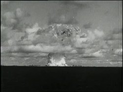 An atomic mushroom clouds spreads over the Pacific Ocean. News Clip