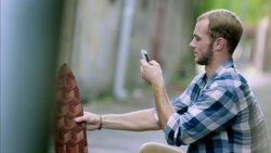 Skater takes smartphone picture of new custom longboard deck Stock Footage