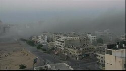Heavy smoke billowing above the rooftops in Gaza News Clip