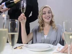 Waiter pouring champagne for woman, rack focus Stock Footage