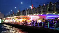 Galata Bridge on an Autumn evening with restaurants and fishermen Stock Footage