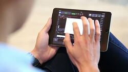 Financial analysts see charts and graphs on the screen of the touchpad Stock Footage