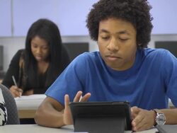 Male Student Interacts uses a Digital Tablet in Classroom Stock Footage