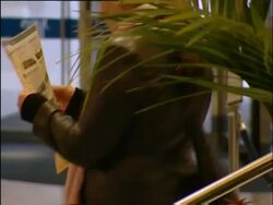 Birmingham, Tourist leaflets in foyer of Jury's Inn hotel; woman picks out leaflet; Jury's Hotel sign and exterior; 2004; short sequence. Stock Footage