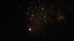 A multitude of fireworks explode, sparkle and cascade against a dark sky. Stock Footage