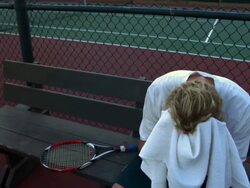 MS, Distressed young man sitting on bench at tennis court, Santa Barbara, California, USA Stock Footage