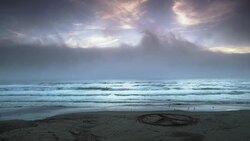 Sunset on Oregon beach with peace sign in sand. Stock Footage
