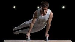 SLO MO Gymnast performing double leg circle on pommel horse Stock Footage