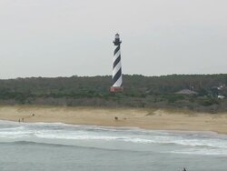 MS AERIAL View of Cape Hatteras Lighthouse and fishermen / North Carolina, United States Stock Footage