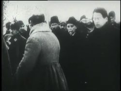 Men lower Vladmir Lenin's coffin from a train as mourners walk through Red Square during his funeral procession. News Clip