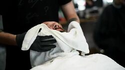 Close-up of beautiful attractive adult man with beard in a barber shop Stock Footage