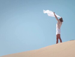 Woman with scarf in desert Stock Footage
