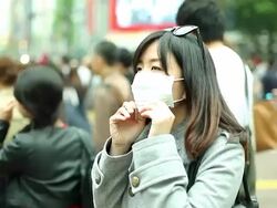 HD:Asian woman wearing a mask standing in a big city. Stock Footage