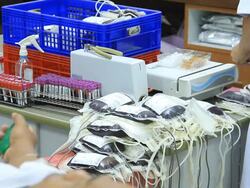 Scientists loading sample vials into centrifuge. Stock Footage