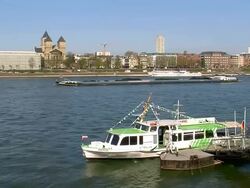 MS Shot of Cargo ships in Rhine river and church St. Kunibert / Cologne, North Rhine Westphalia, Germany Stock Footage