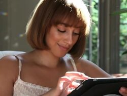 Woman types on tablet at home Stock Footage