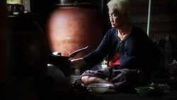 Pitiable Senior asian woman Sitting a Cooking Food Stock Footage