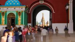 Russia, Moscow, St Basil's Cathedral visible through the Iberian Chapel and Resurrection Gate leading into Red Square - Time lapse Stock Footage
