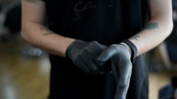 male hairdresser wears gloves in Barbershop Stock Footage