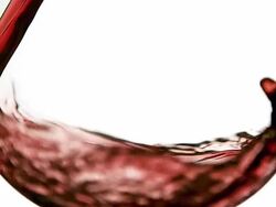 ECU SLO MO Red wine pouring into glass against white background / Vieux Pont, Normandy, France Stock Footage
