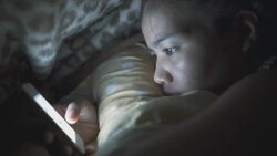 Close up of a young women playing game under blanket Stock Footage