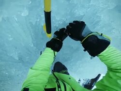 POV ice climber placing an ice screw into the slope Stock Footage