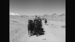 WS POV Cowboys riding in carriages in desert / United States News Clip