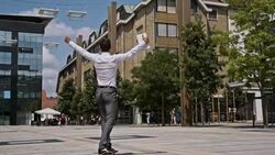 SLO MO Successful yuppie showing joy on a skateboard Stock Footage
