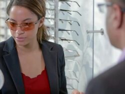 Customer tries on sunglasses at an optician Stock Footage