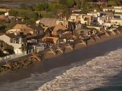 Aerial TS MS along residential beachfront homes / Malibu, California, United States.  Stock Footage