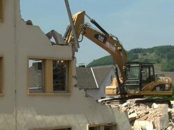 MS bulldozer at demolition of apartment block / Saarburg, Rhineland-Palatinate, Germany Stock Footage