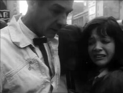B/W 1963 close up man + two women crying outdoors after John Kennedy's assassination / newsreel Stock Footage