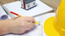 young architect working on blueprints in office Stock Footage