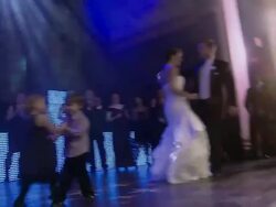 small boy and girl dance together as bride and groom dance on stage Stock Footage