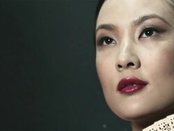 Young woman covering face with oriental fan Stock Footage