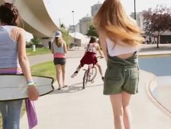Teenage girls walking at skateboard park Stock Footage