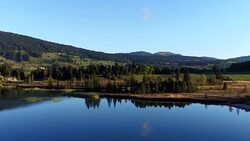 aerial view of lake and mountain in Jura Stock Footage